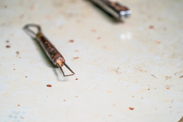 Photo used carving equipment on the white table after carve the wax model art.