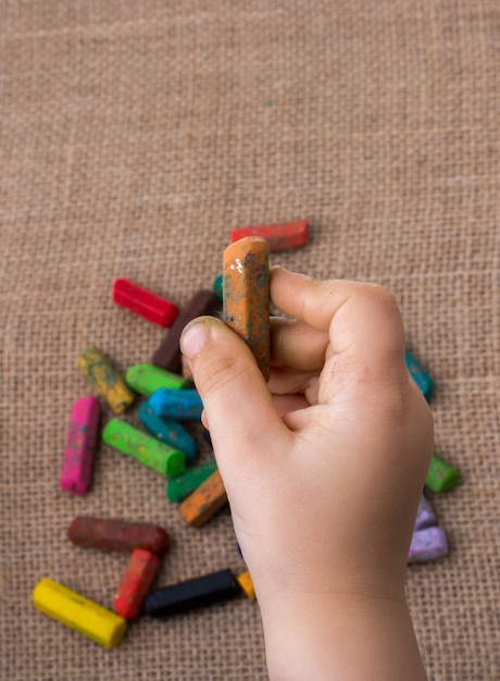 Used color crayons and a toddlers hand holding one