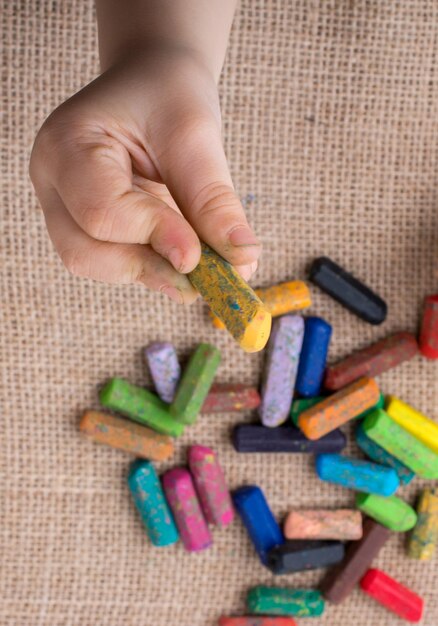 Foto pastelli a colori usati e una mano per bambini