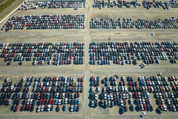 Photo used damaged cars on auction reseller company big parking lot ready for resale services sales of secondhand vehicles for rebuilt or salvage title