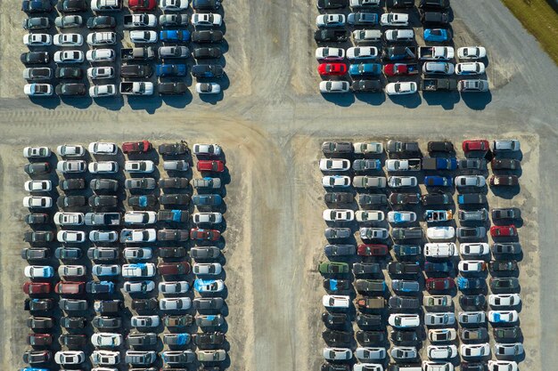 Photo used damaged cars on auction reseller company big parking lot ready for resale services sales of secondhand vehicles for rebuilt or salvage title