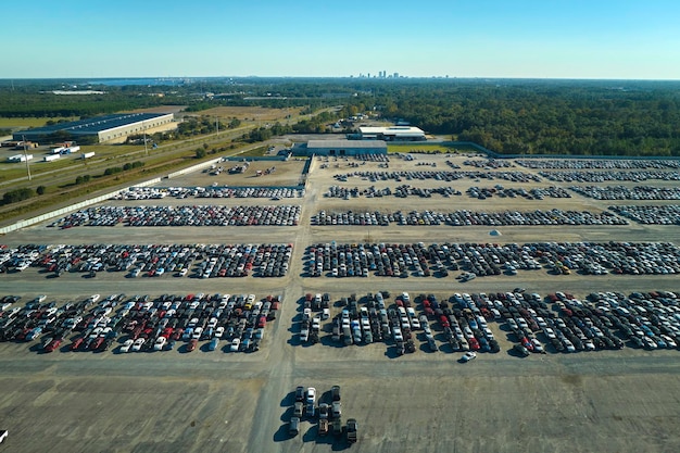 Photo used damaged cars on auction reseller company big parking lot ready for resale services sales of secondhand vehicles for rebuilt or salvage title