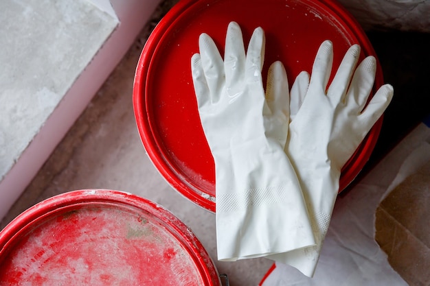 Used latex gloves on a paint bucket
