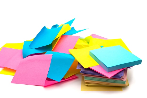 Used and new colorful sticky note paper heap isolated on white