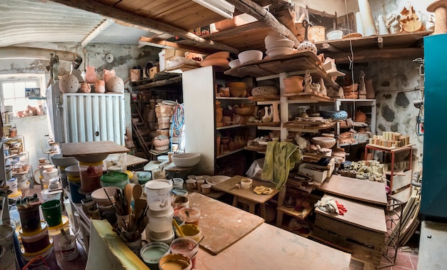 Photo used painting buckets and brushes in ceramic workshop