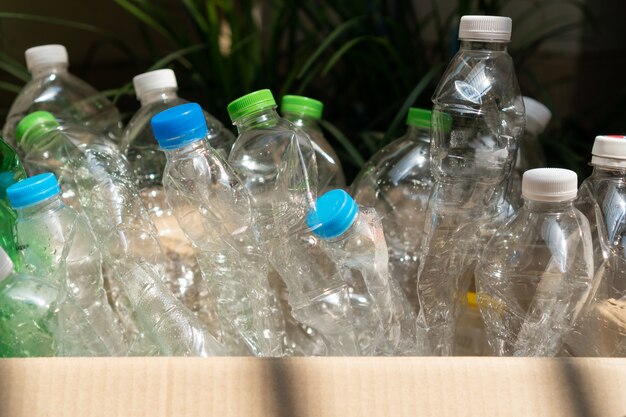 Used plastic bottle in the box, Recycling plastic utilisation concept. Ecological problem, environmental pollution. Close up