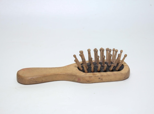 Used wooden comb on a white background