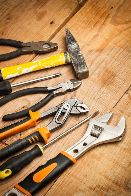 Used work tools on a wooden table in a top view