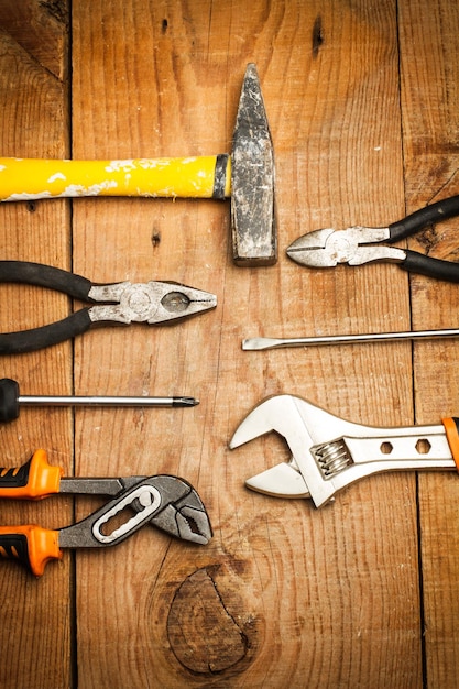 Photo used work tools on a wooden table in a top view