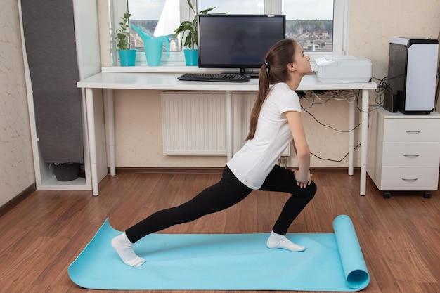 Useful activities during quarantine Girl does gymnastics online on the Internet