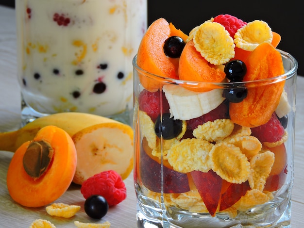 Useful breakfast with fruit berries flakes and yogurt. Berries fruit flakes. 