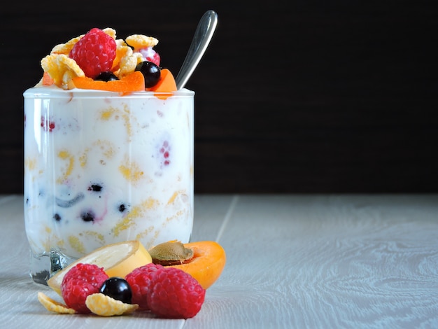 Useful breakfast with fruit berries flakes and yogurt. Berries fruit flakes. 