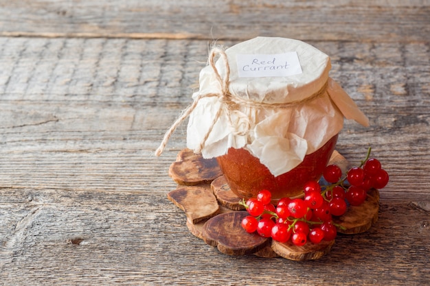 Useful currant jam in a glass jar. Fresh red currant 