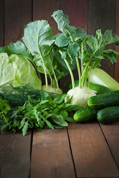 Useful green vegetables on a wooden table