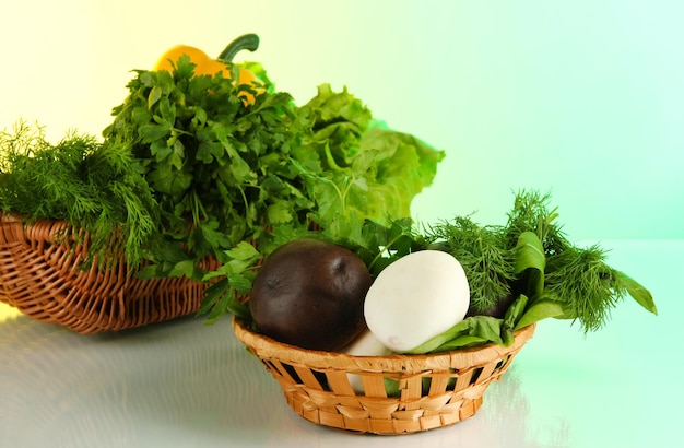 Useful herbs mushrooms and pepper in basket on light background