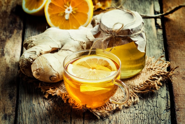 Useful tea against colds with honey lemon and ginger Vintage wood background selective focus