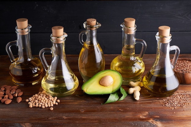 Useful vegetable oils in glass bottles. Avocado oil, chickpea oil, linseed oil, peanut oil, almond oil.