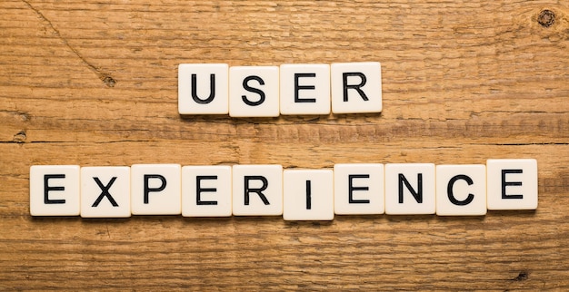 User experience sign with wooden cubes on background