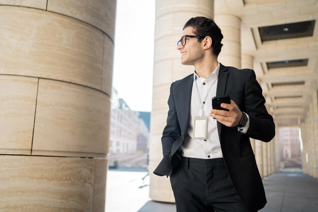 Uses a phone from a businessman a man in a business suit goes to work in the office