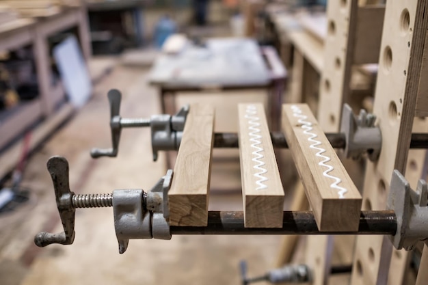 Using clamps and glue to connect wooden timbers for furniture detail