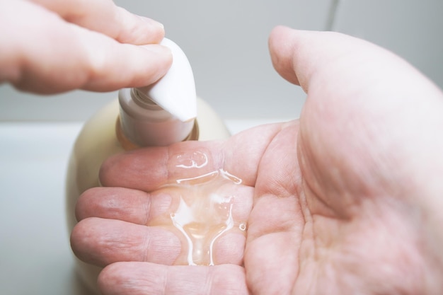 Using liquid soap dispenser before washing hands