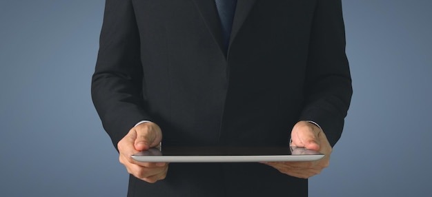 Using modern technologies young man in shirt tablet in hand