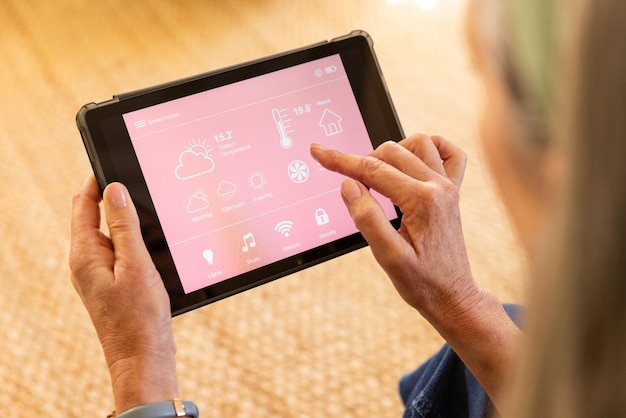 using tablet woman controlling smart home settings and monitoring temperature