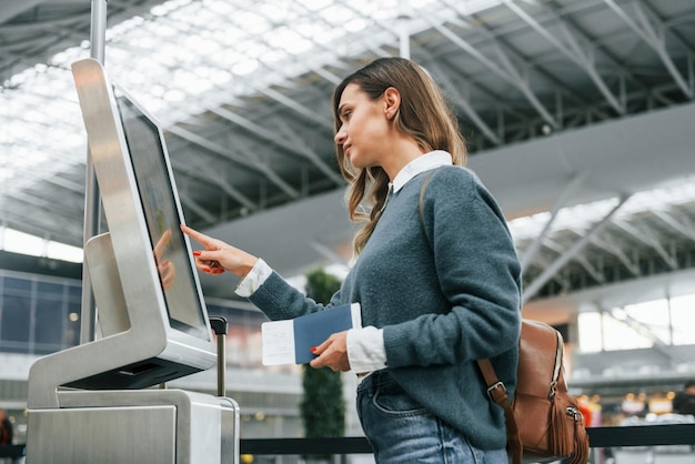 Photo using terminal young female tourist is in the airport at daytime