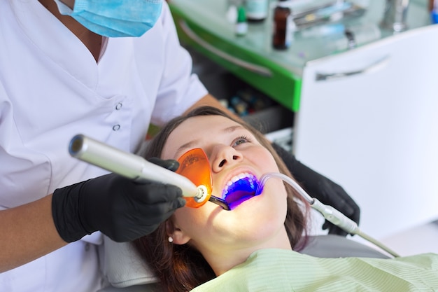 Using UV ultraviolet lamp for dental treatment in dental office.