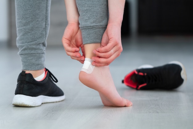 Using white medical adhesive plaster from calluses during wearing a new shoe