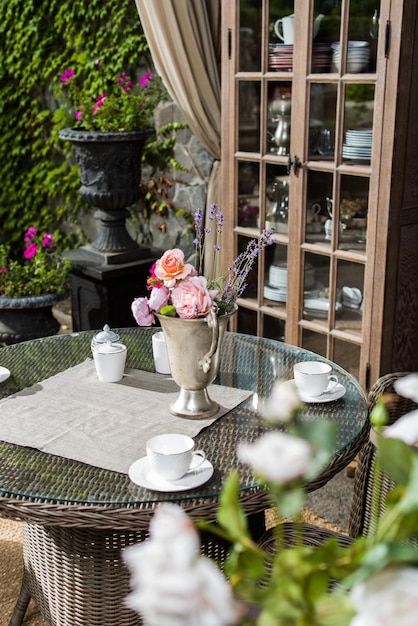 Photo utensils made of glass and porcelain on the dining table outdoor furniture