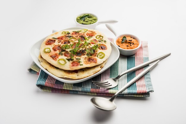 Uthappam or uttapam is a type of dosa from South India which is thicker, with tomato, onion and chilli toppings