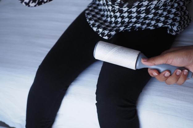 Utilizing a lint roller on dark pants ensures a neat and clean look for your outfit