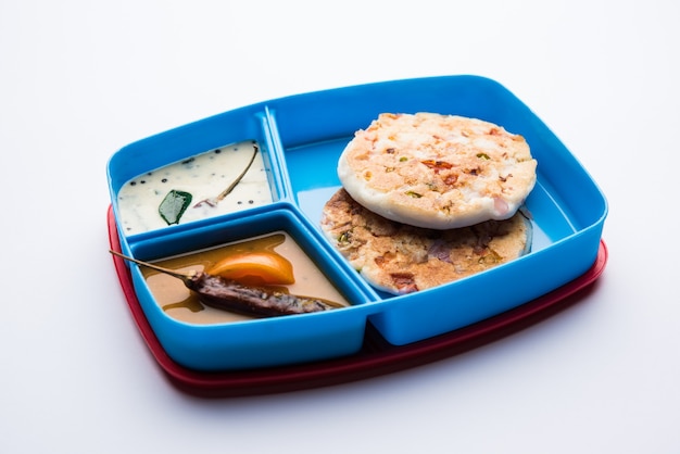 Uttapam or uthappam sambar chutney in lunch box or tiffin