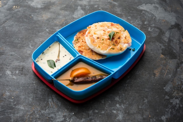 Uttapam or uthappam sambar chutney in lunch box or tiffin