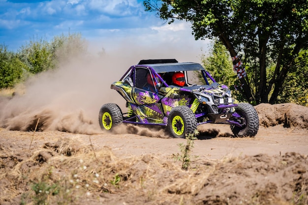 UTV vehicle offroad kicking up sand on dune Extreme adrenalin 4x4