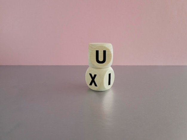 UX design or UI design Turned cube and changed the words 'UX' to 'UI' Beautiful pink background