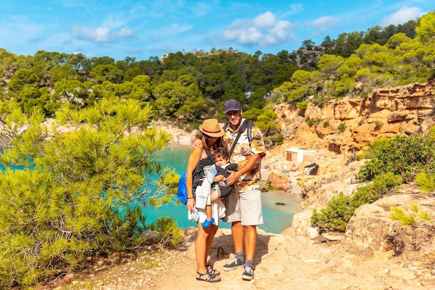 Vacation concept A family with their child at Playa Salada and Saladeta on the coast of Ibiza Balearic