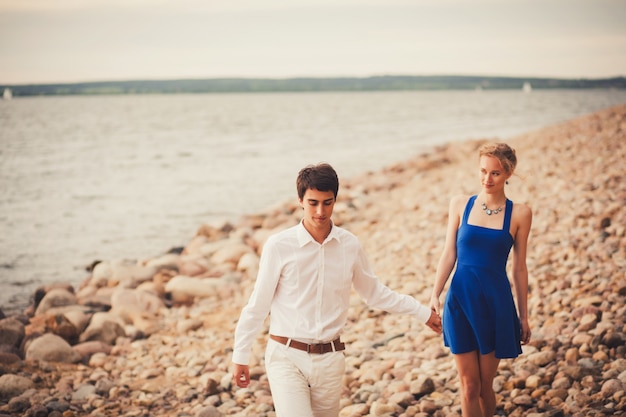 Vacation couple walking on beach together