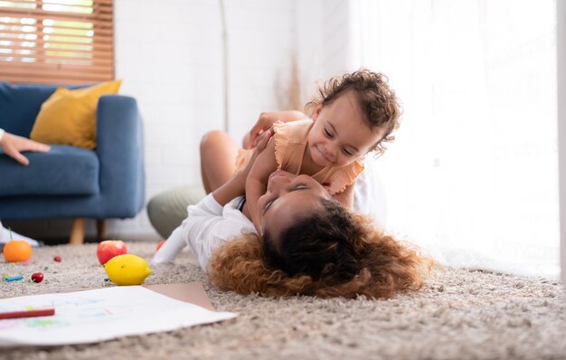 On a vacation morning parents and children are having fun playing in the living room