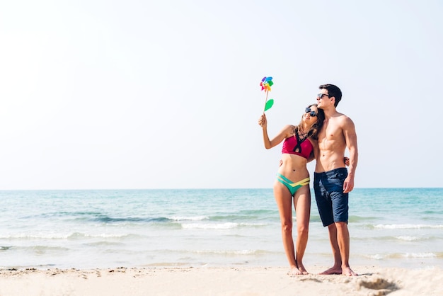 Vacation romantic love young happy smile couple in honeymoon travel holiday trip standing on sand at blue sky sea beach having fun and relaxing together on tropical beachSummer travel