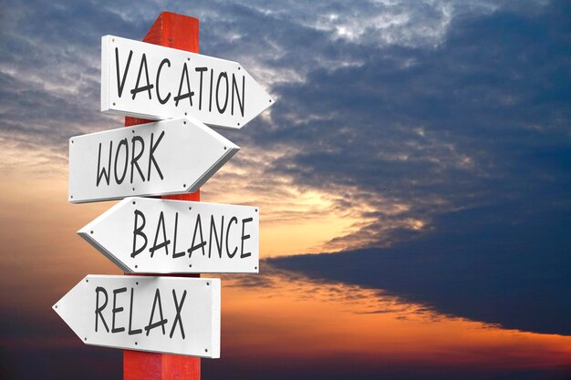 Vacation work balance relax wooden signpost with four arrows