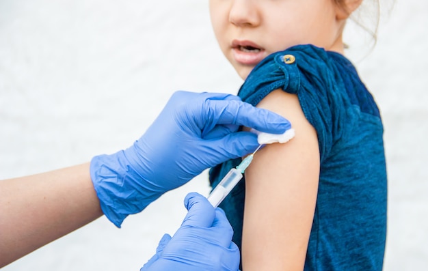 Vaccination of children. An injection. Selective focus.