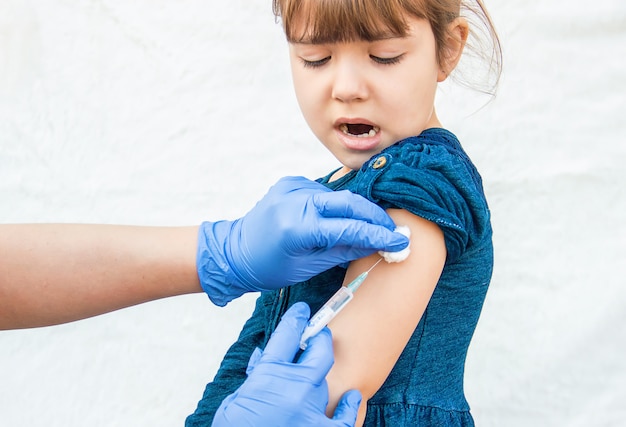 Vaccination of children. An injection. Selective focus.