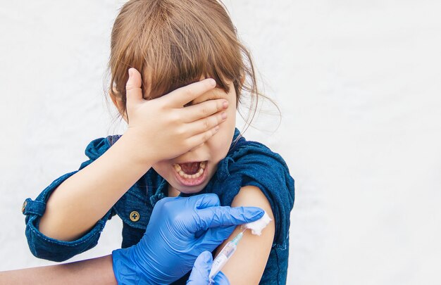 Vaccination of children. An injection. Selective focus.