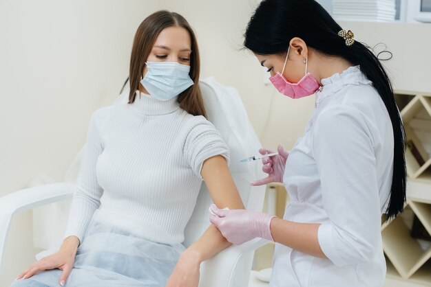 Vaccination of a girl against flu and coronavirus infection during a worldwide pandemic. 