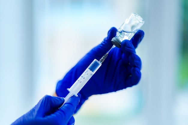 Vaccination of people during an epidemic and viral infectious diseases. using syringe for injection of an antibiotic to a patient in a hospital. flu shot close-up