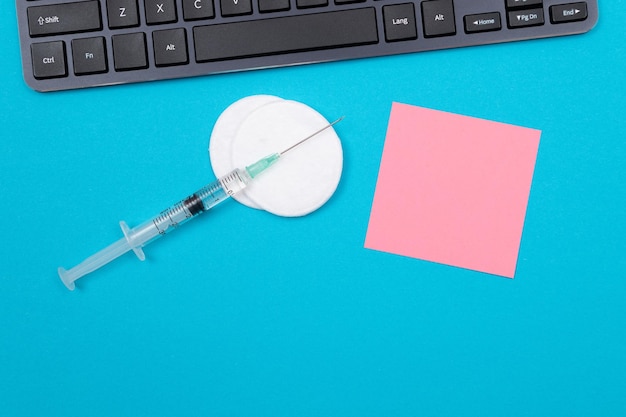 Vaccination or revaccination concept a medical syringe on blue table