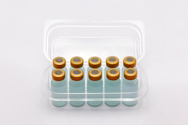 vaccine bottles inside opened translucent plastic box