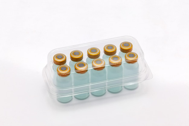 vaccine bottles inside opened translucent plastic box